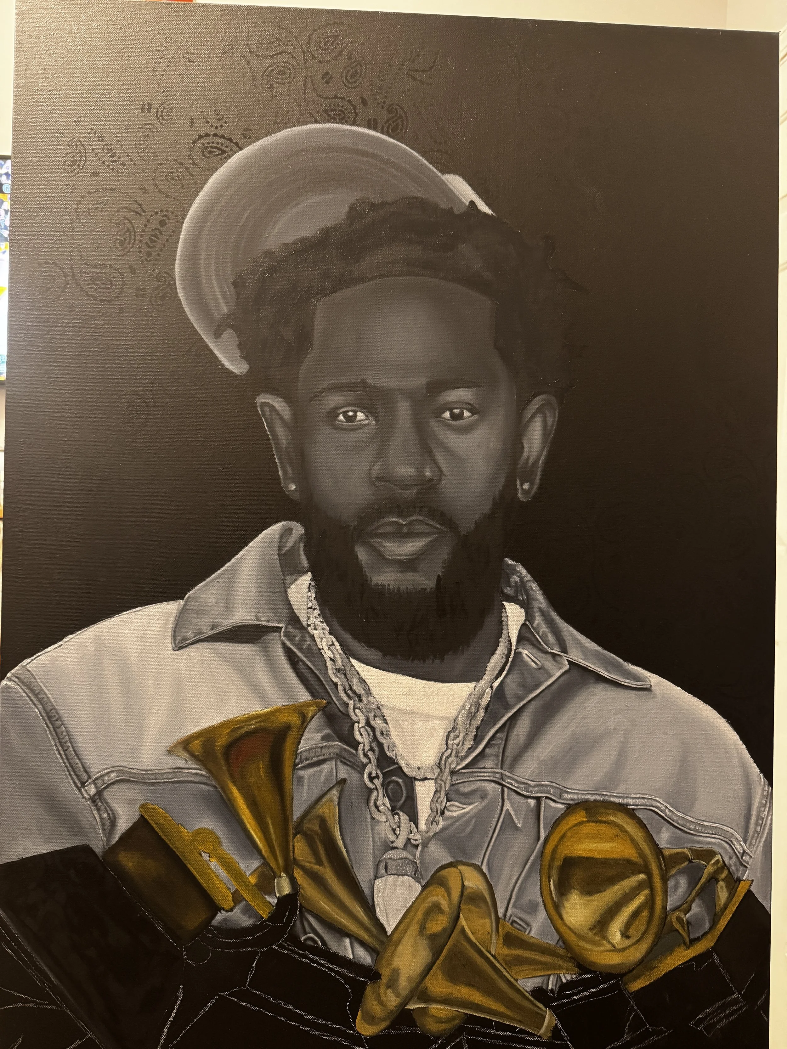 Black and white portrait of a young man with dreadlocks, beard, and earrings, wearing jewelry and a denim jacket, with a halo and saxophone illustrations behind him.