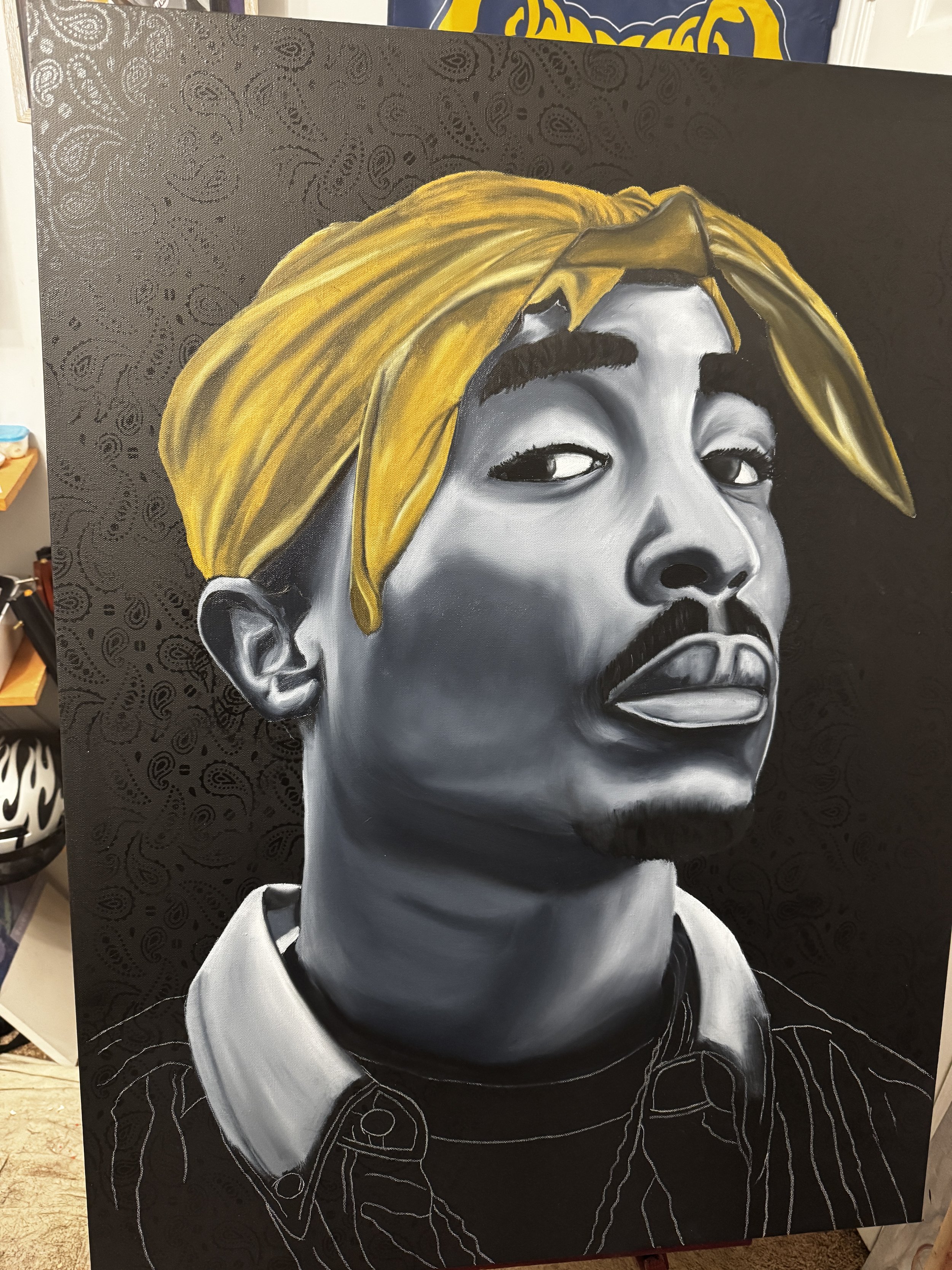 A black and white portrait painting of a young man with a serious expression, wearing a yellow bandana and a collared shirt, with unfinished outline details.