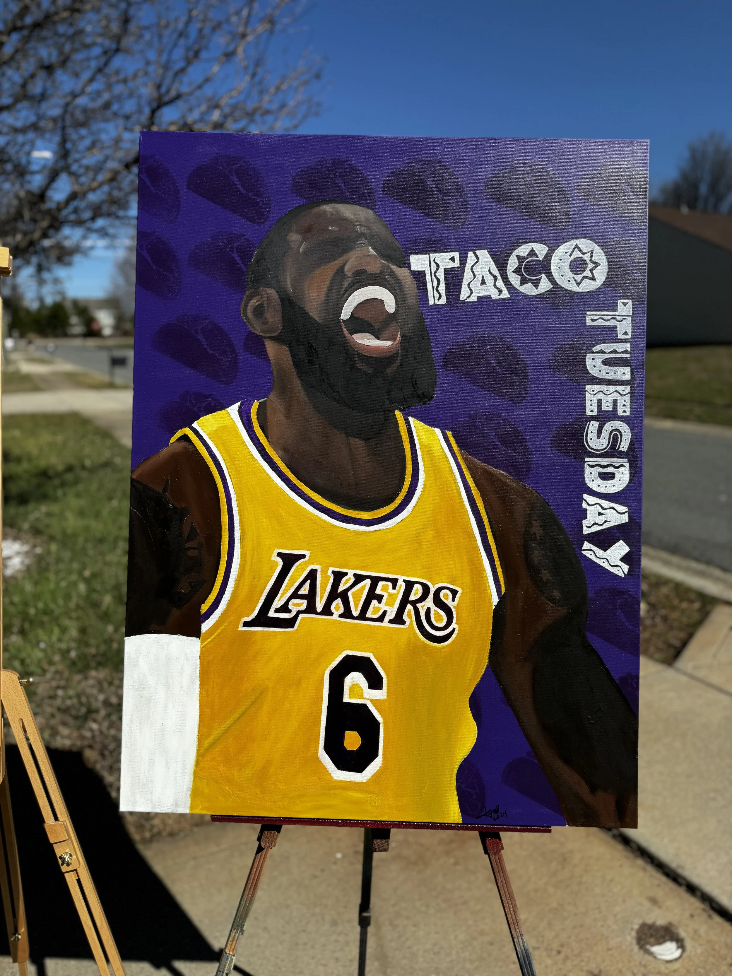 Painting of a man in a yellow Los Angeles Lakers basketball jersey with the number 6, laughing with his mouth open, set against a purple background with repeated images of taco shells and the words "Taco Tuesday".