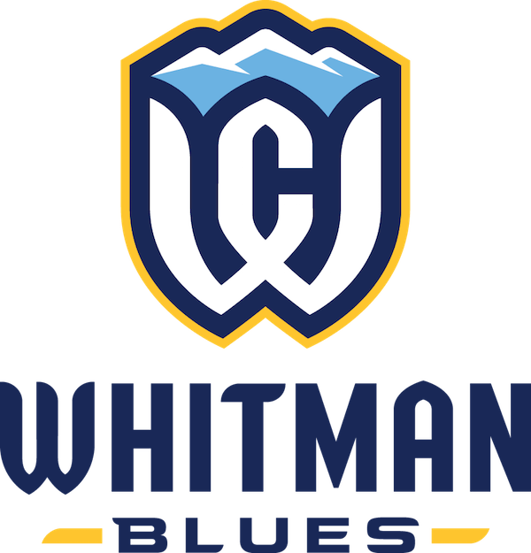 Whitman Blues logo featuring a shield with mountain peaks and a large stylized 'W' at its center, with the text 'WHITMAN BLUES' below.