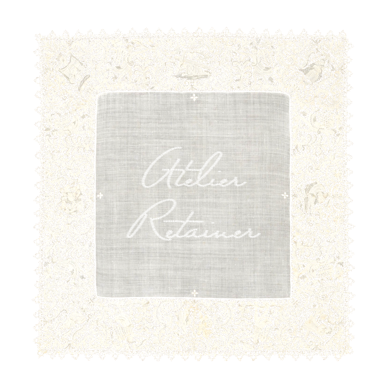 A white embroidered cloth with the words "Atelier Retainer" in elegant cursive, surrounded by intricate lace and decorative elements.