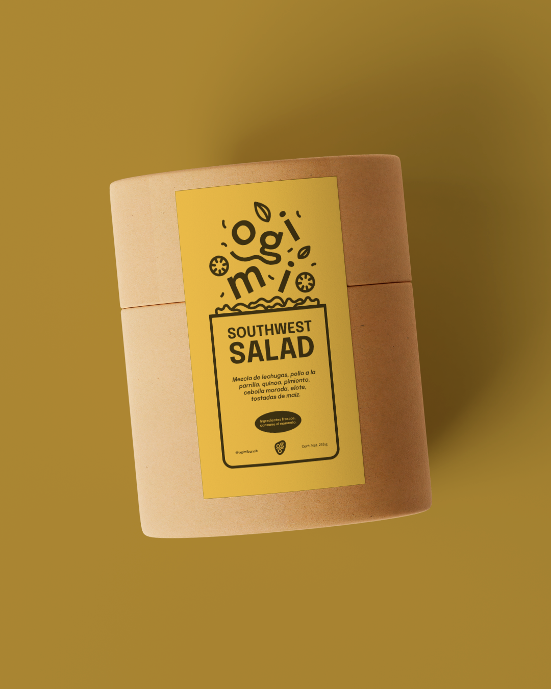 A cylindrical cardboard container by Ogimi Bunch with a yellow label that reads 'Southwest Salad' and additional text in Spanish, set against a matching yellow background.