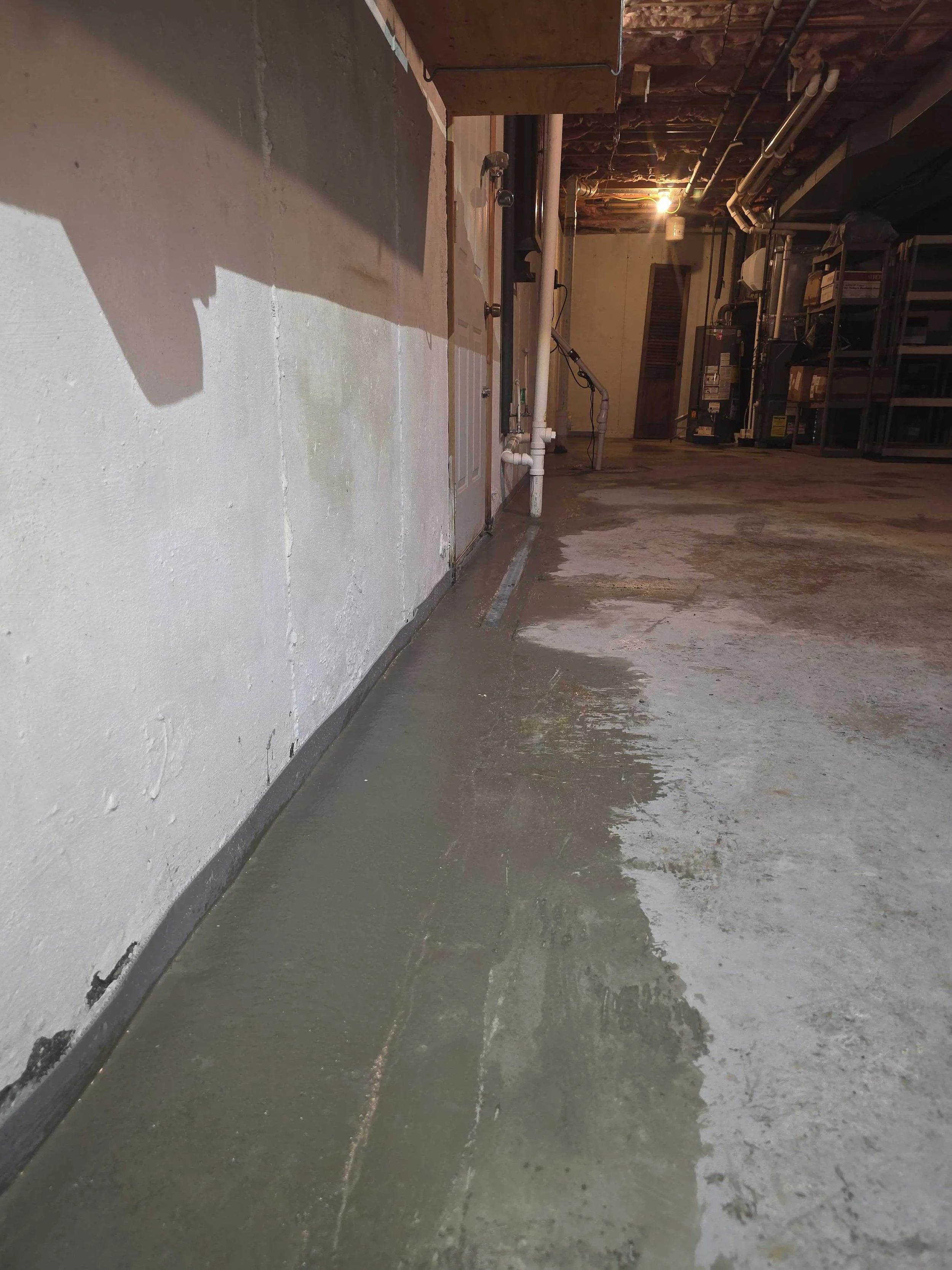Completed basement perimeter drainage system installed by Broman Basement Solutions in Southern New Hampshire