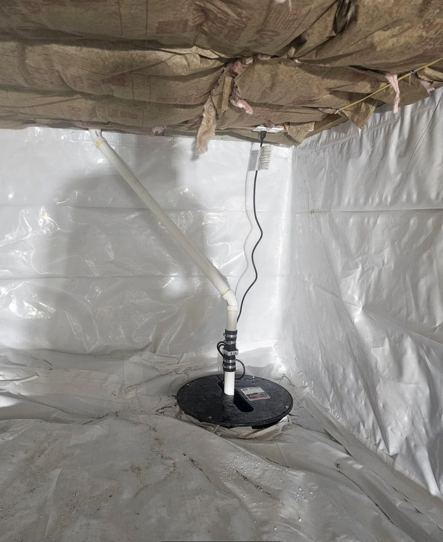 Completed basement sump pump and drainage system installed by Broman Basement Solutions in Southern New Hampshire
