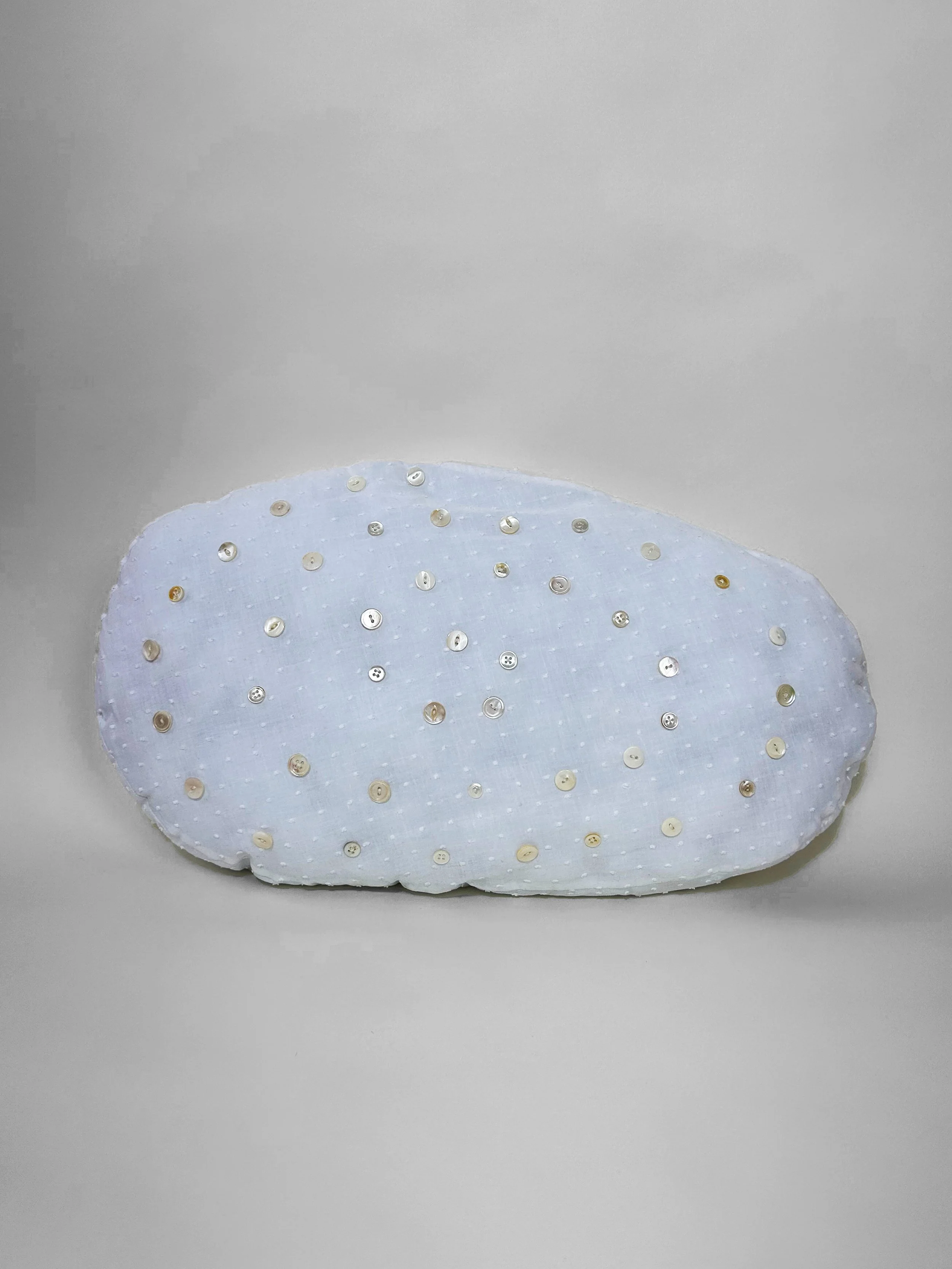 "Freshwater Double Spiral" cotton, polyester thread, mother of pearl buttons, polyfil, 13" x 23" x 3 1/2", 2023