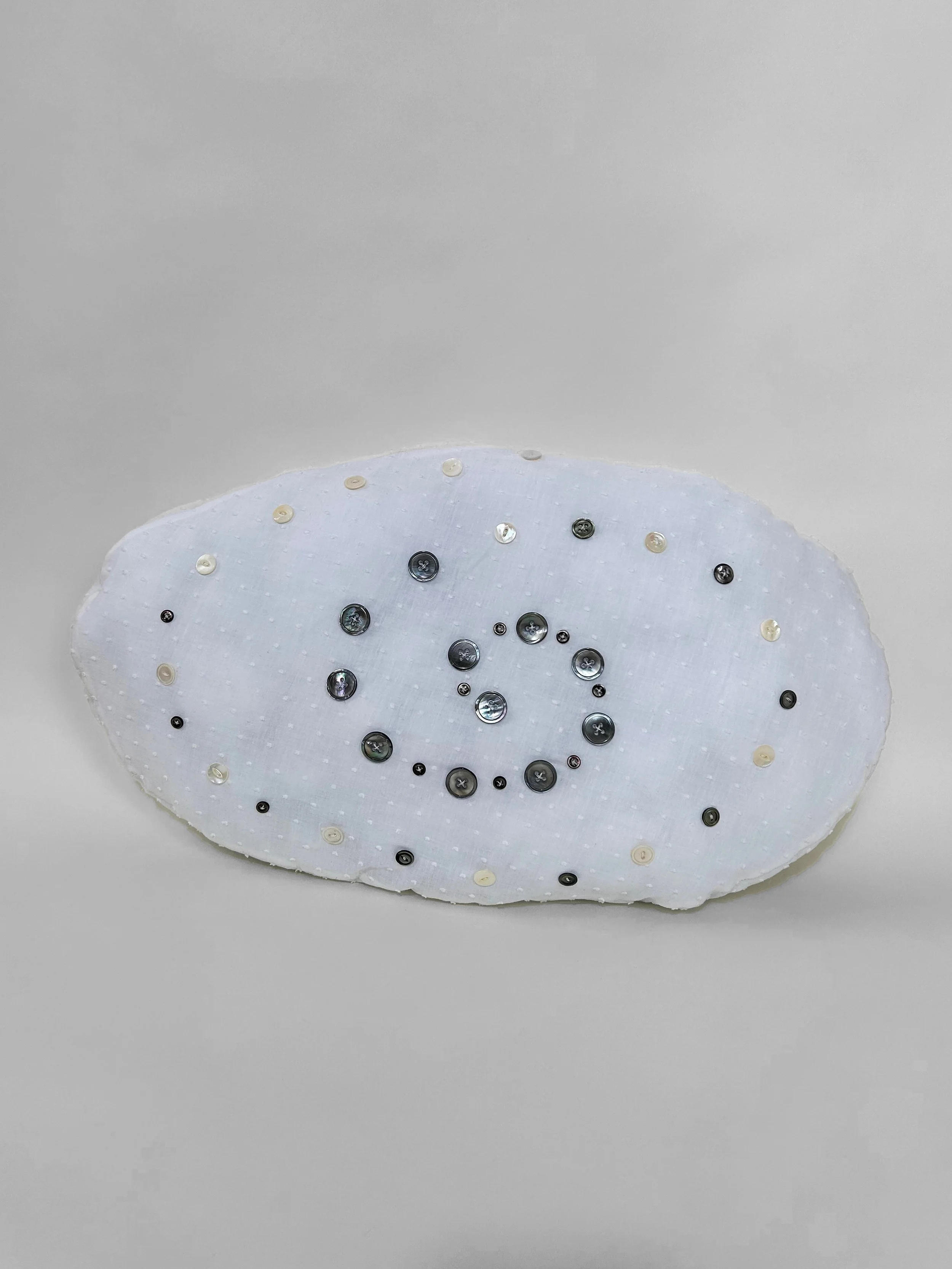 "Freshwater Double Spiral" cotton, polyester thread, mother of pearl buttons, polyfil, 13" x 23" x 3 1/2", 2023