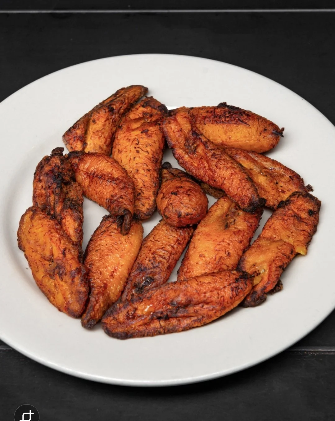 Plate of grilled chicken wings with a spicy seasoning.