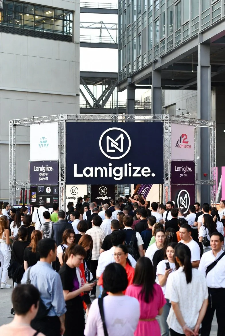 Crowd gathered at an event in an urban outdoor setting.