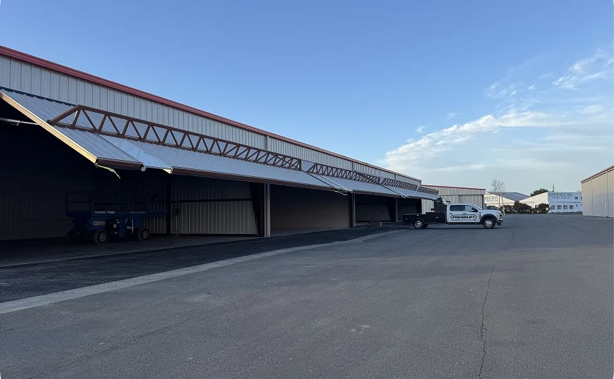Long industrial building with canopy-style hydraulic doors in California.