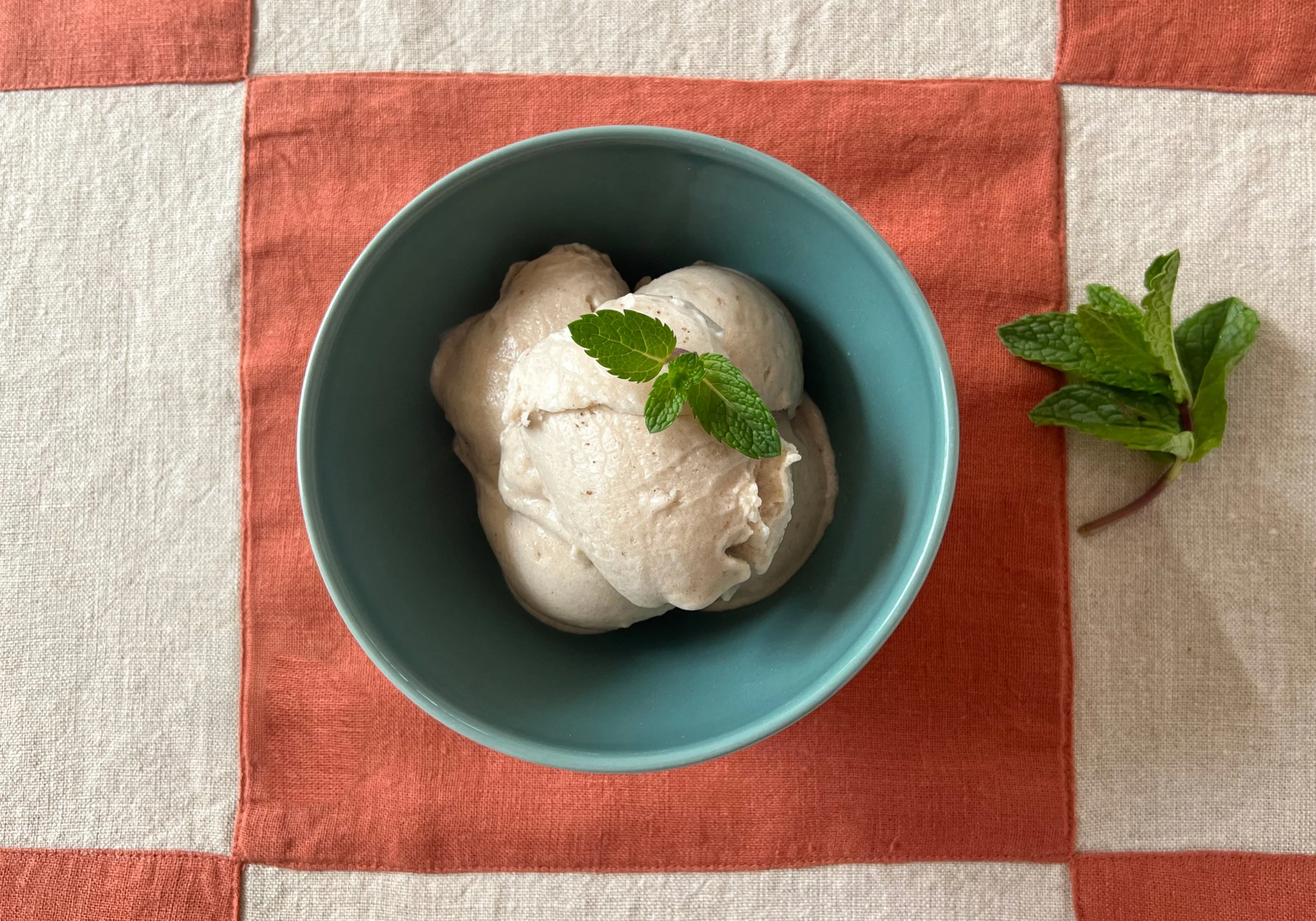 banana honey ice cream in a bowl with mint garnish