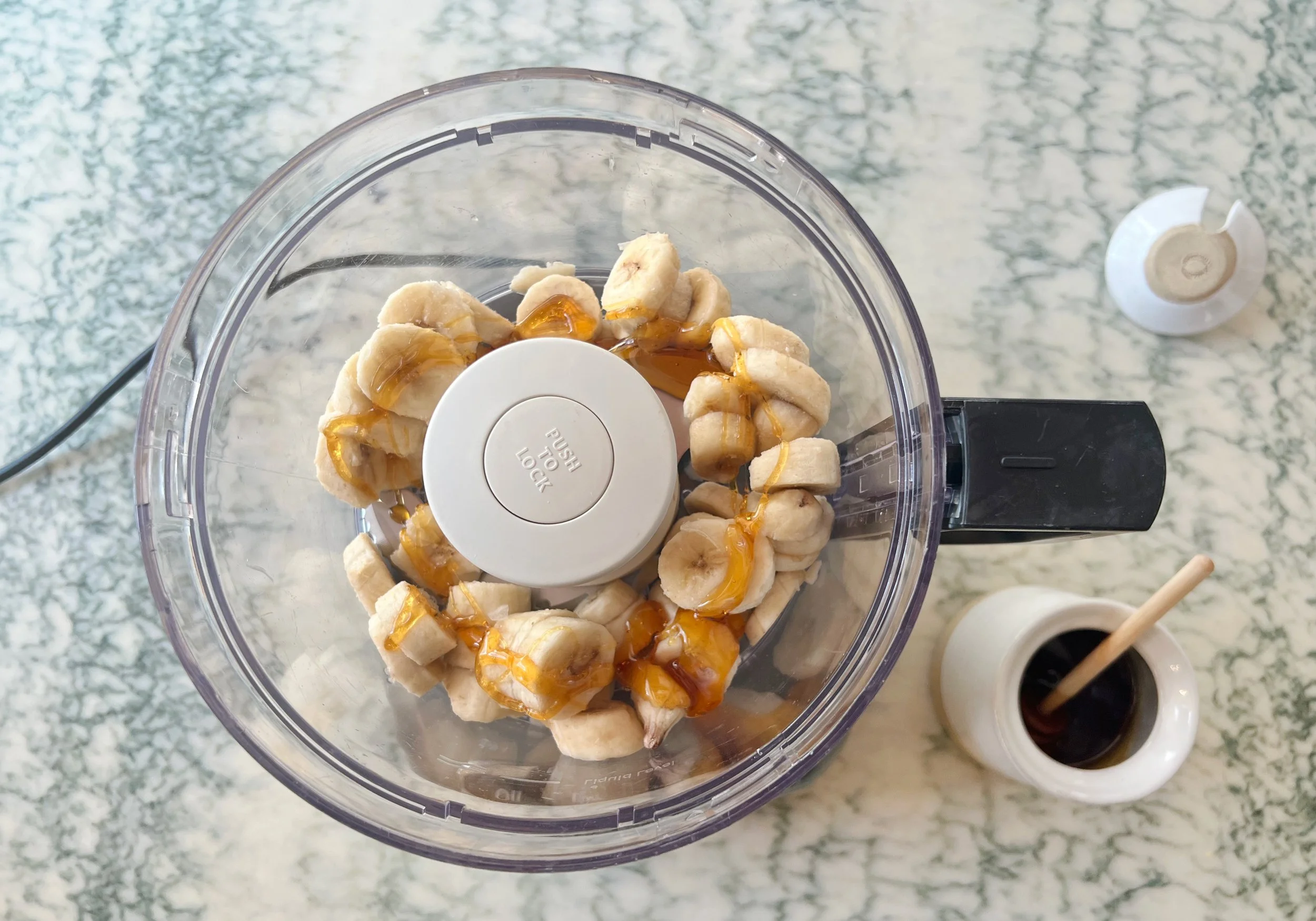 frozen chopped bananas and honey in a food processor