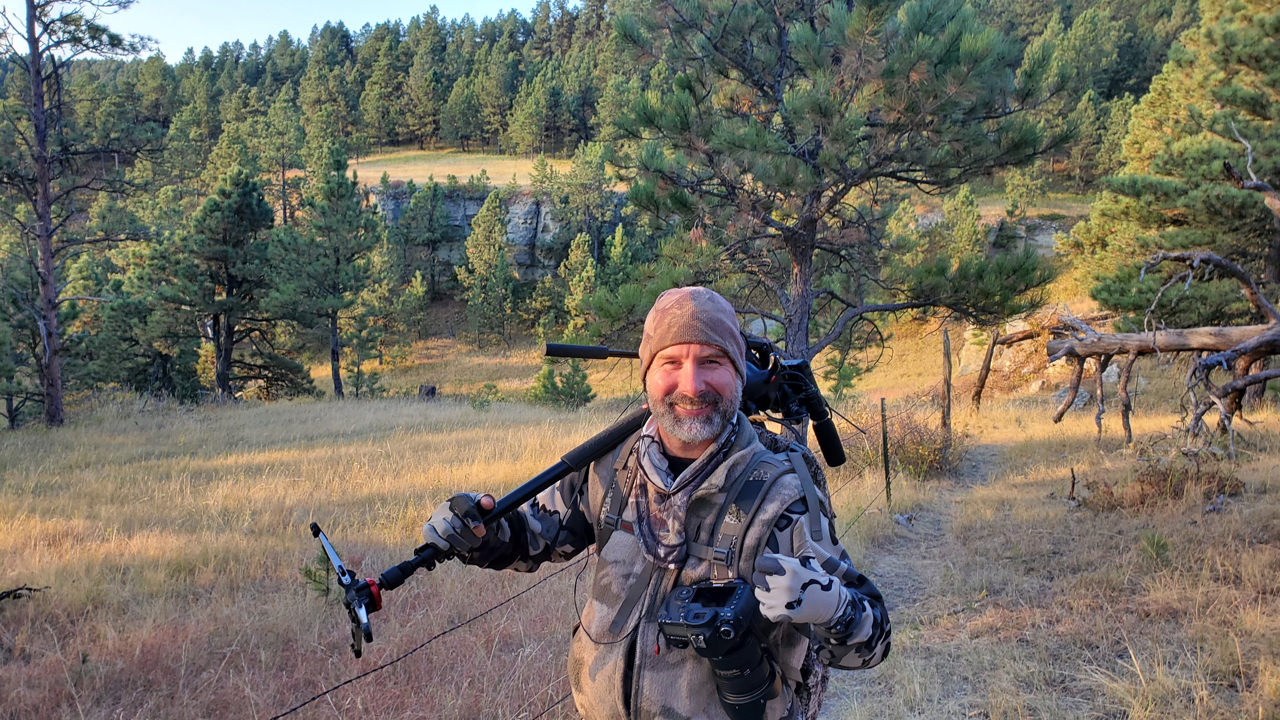 Picture shows owner with camera gear. Trusted. Experienced.