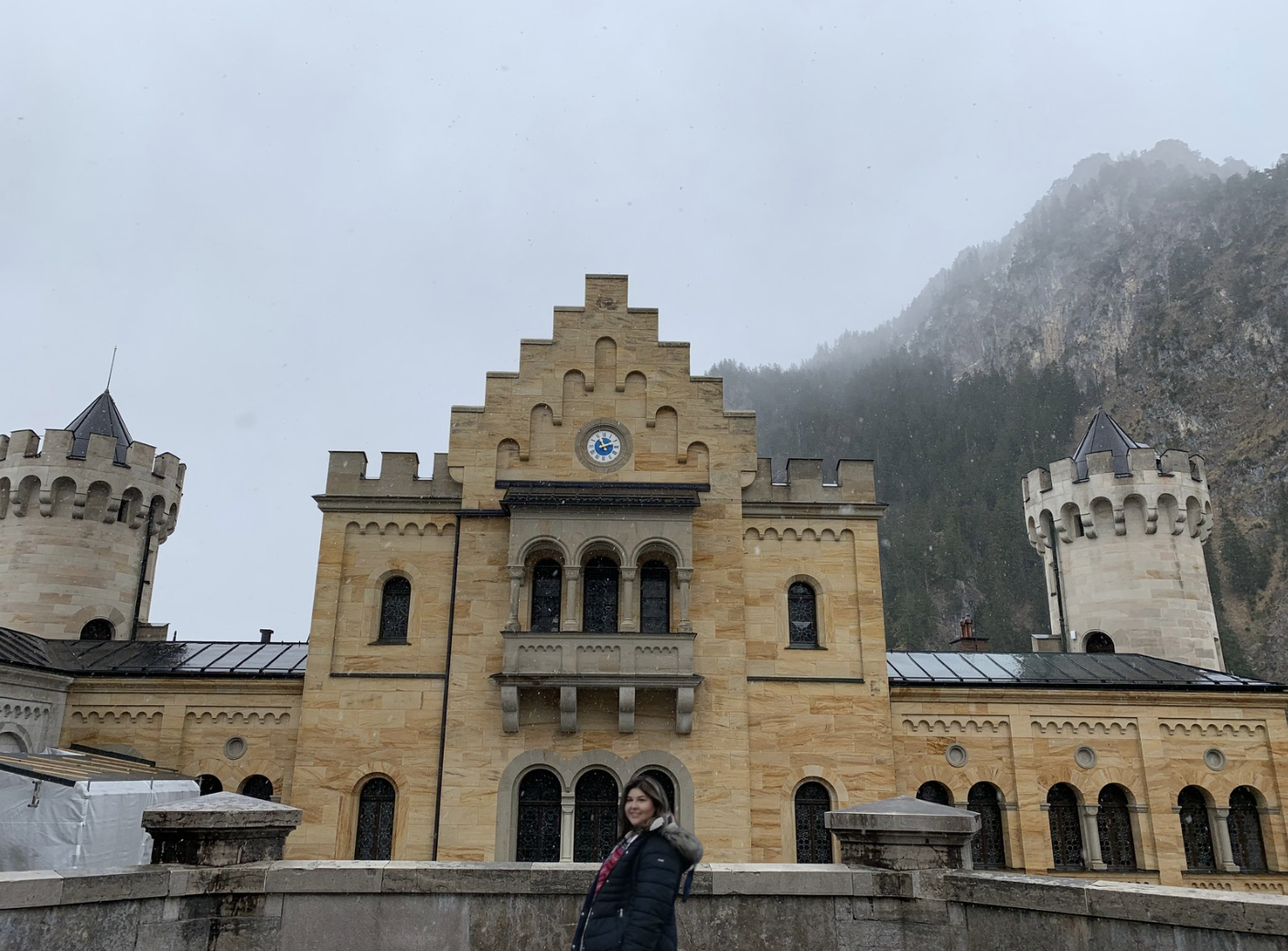 The founder of Timeless Curated Collection—an antique home decor website—standing in front of Neuschwanstein Castle.