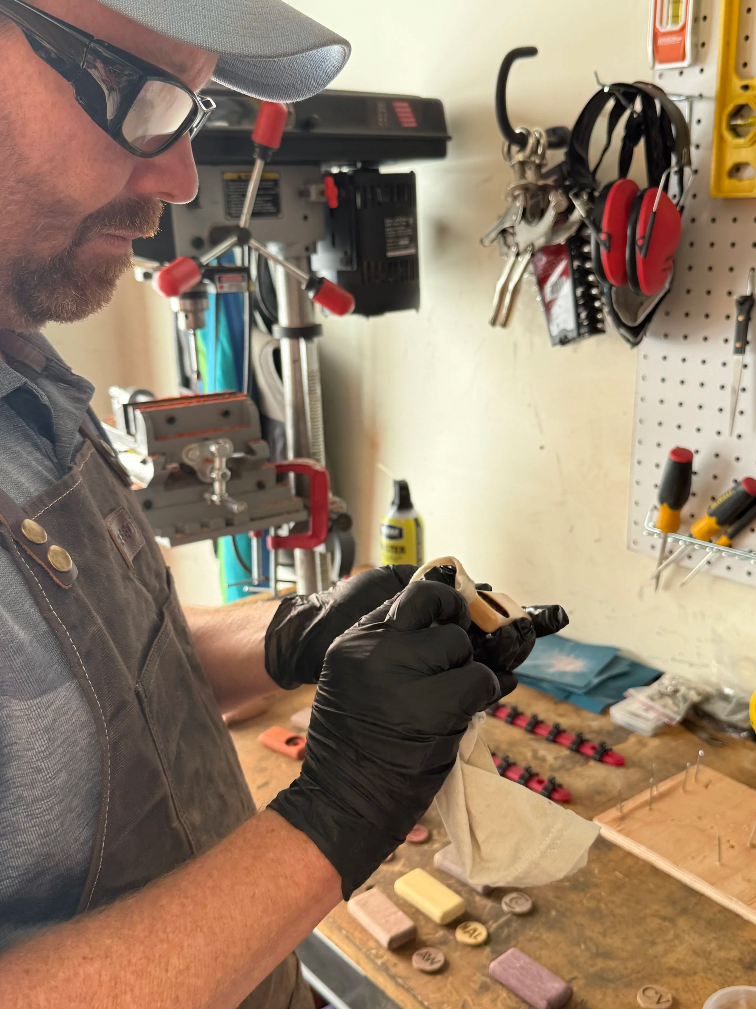 The Divsmith founder Nathan hand-finishing an exotic hardwood golf divot tool with Osmo oil in his workshop