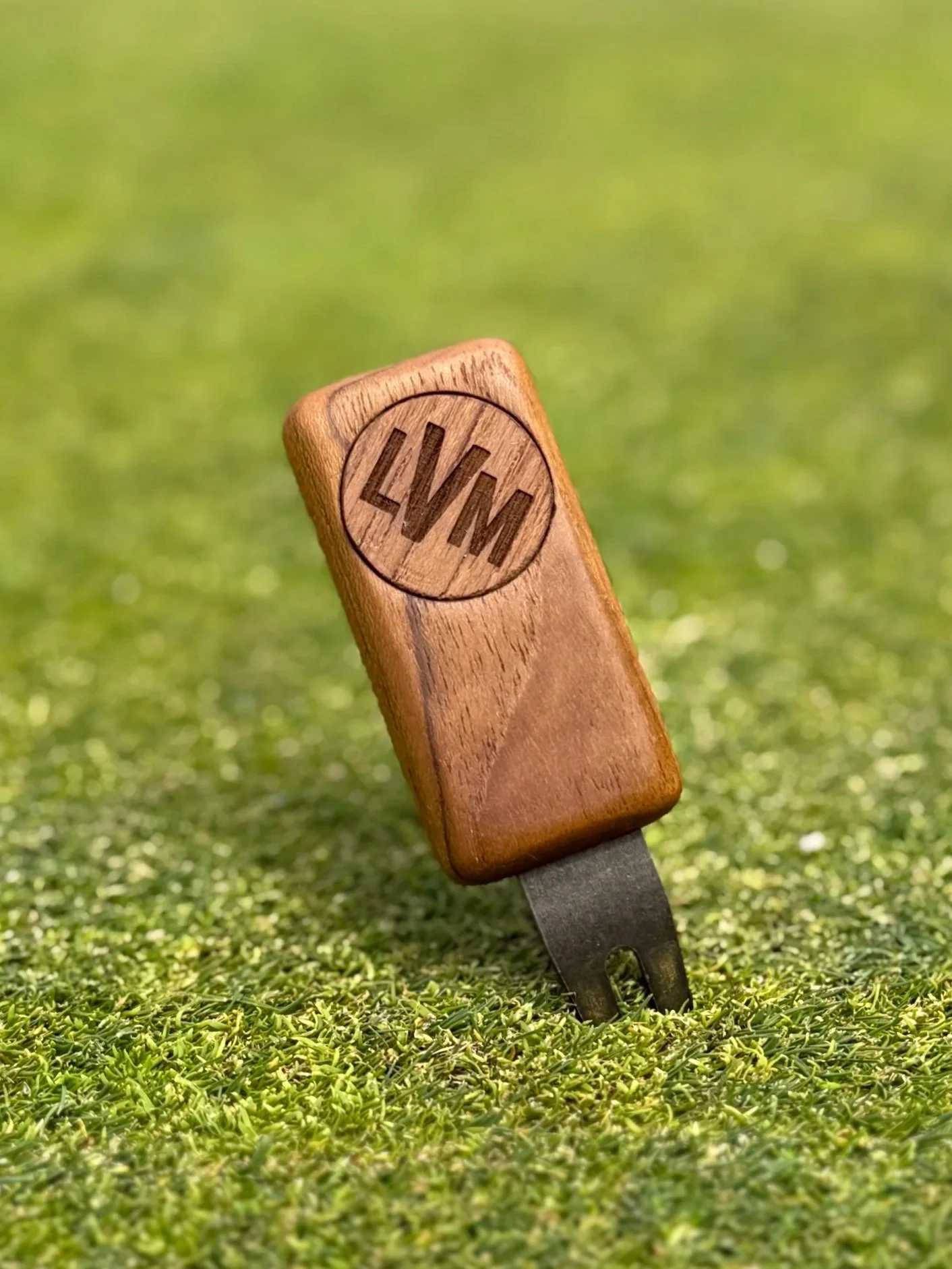 Personalized teak wood golf divot tool with custom initialed wooden ball marker on putting green — The Divsmith