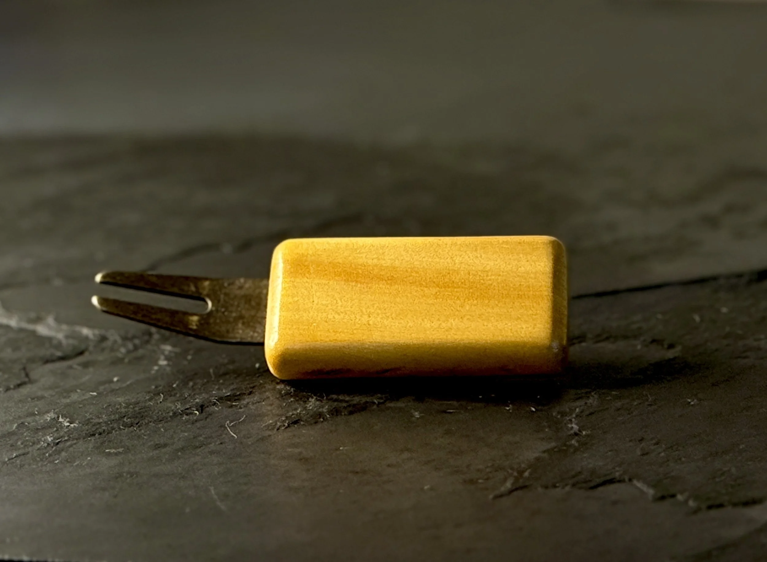 Handcrafted yellowheart wood golf divot tool with antiqued brass hardware