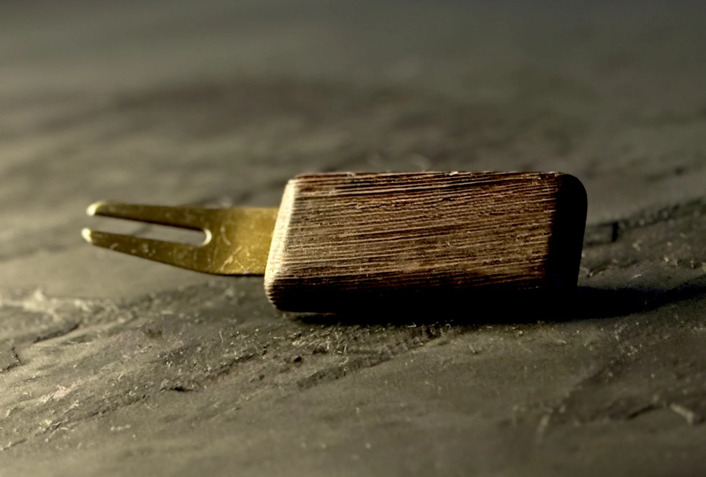 Handcrafted wenge wood golf divot tool with antiqued brass hardware