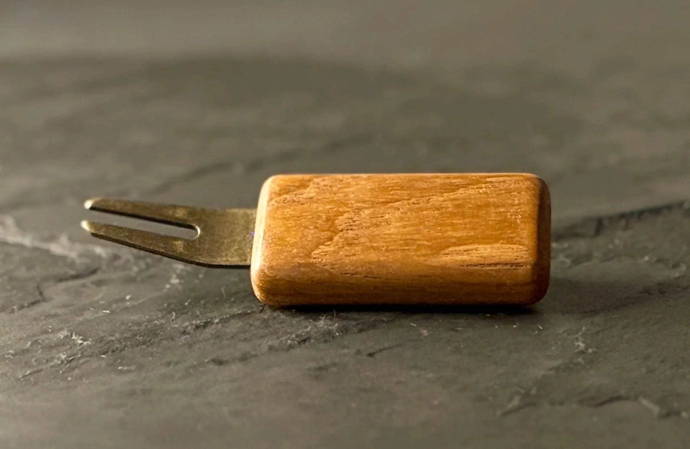 Handcrafted teak wood golf divot tool with antiqued brass hardware