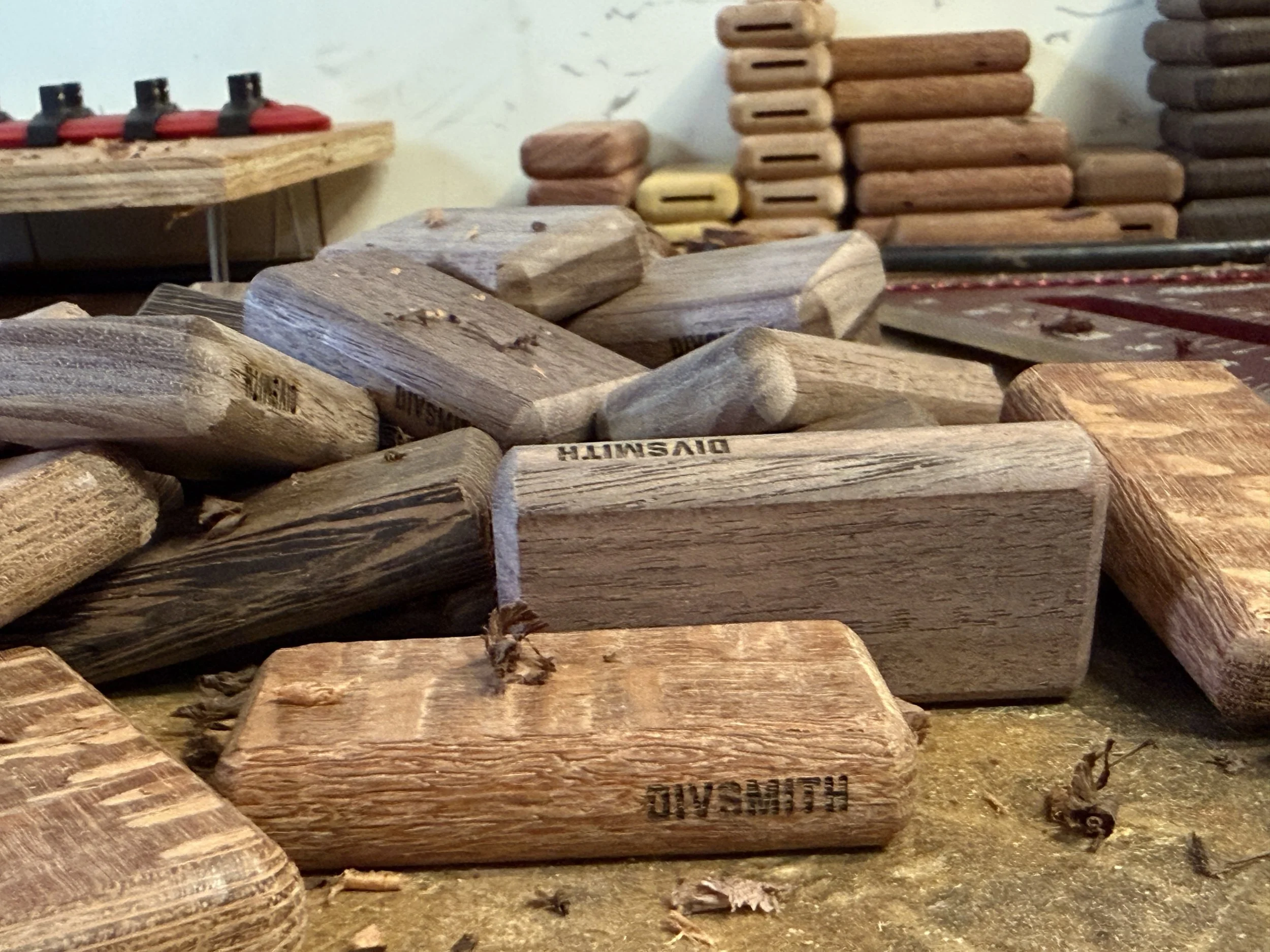 Handcrafted exotic hardwood golf divot tools in various stages of production at The Divsmith workshop