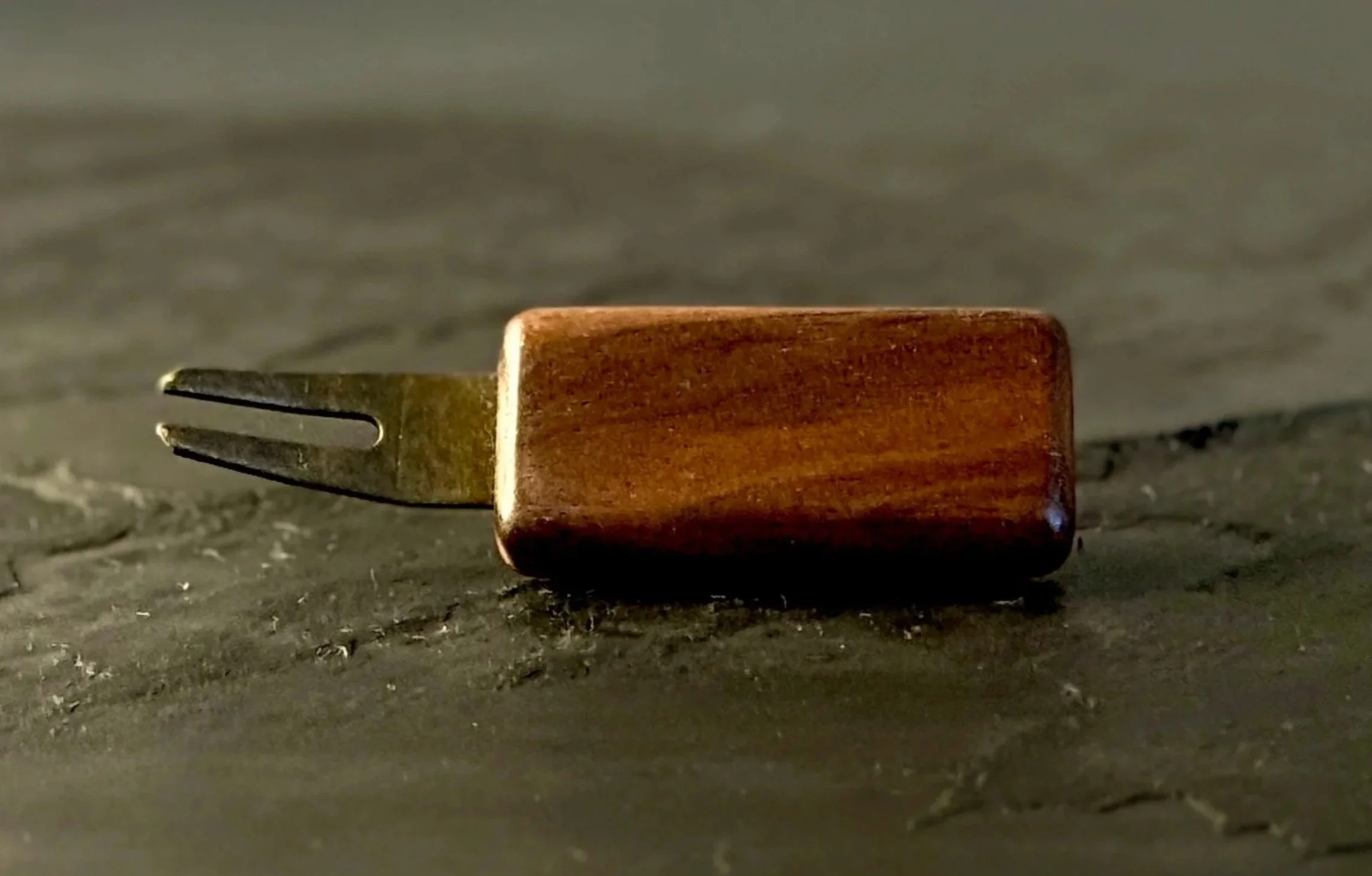 Handcrafted walnut wood golf divot tool with antiqued brass hardware