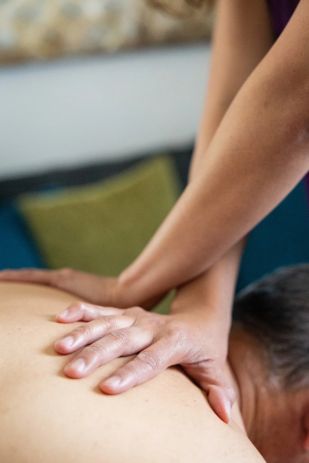 Shift Mind Body Spirit_Myofascial Release Therapy_Berkeley, CA_Close-up of a person receiving a massage, with hands pressing on the back.