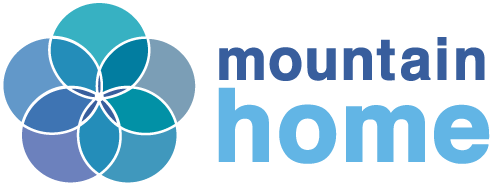 Logo of Mountain Home, featuring a stylized flower with overlapping blue petals and the text 'mountain home' in blue.