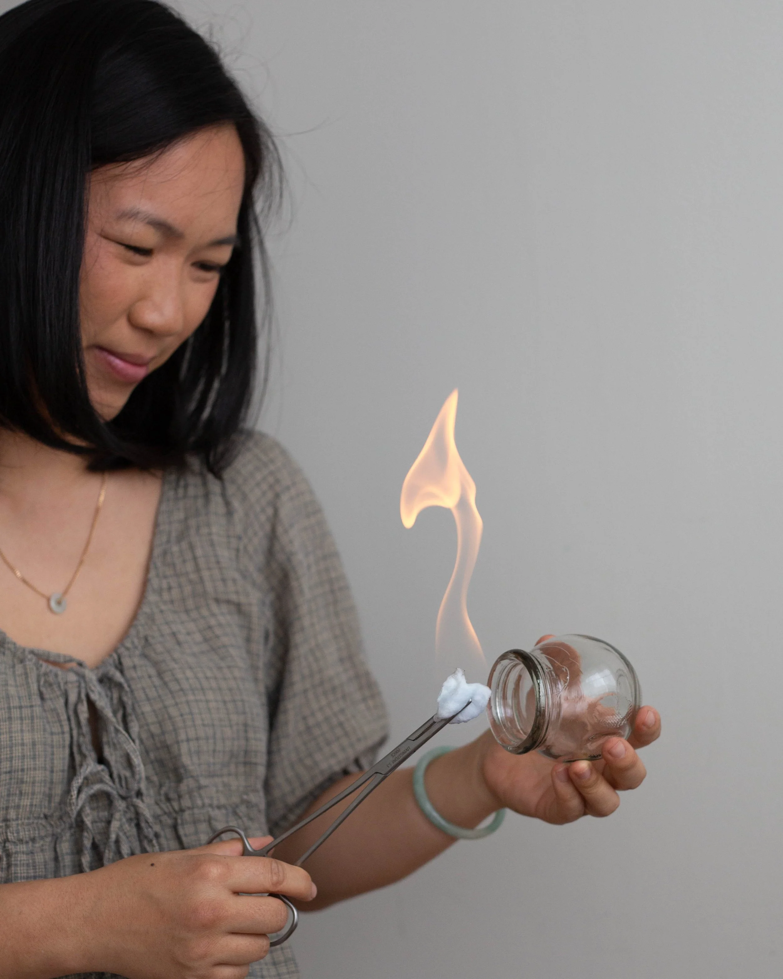 Acupuncturist Cassie Young preparing cupping treatment in clinic