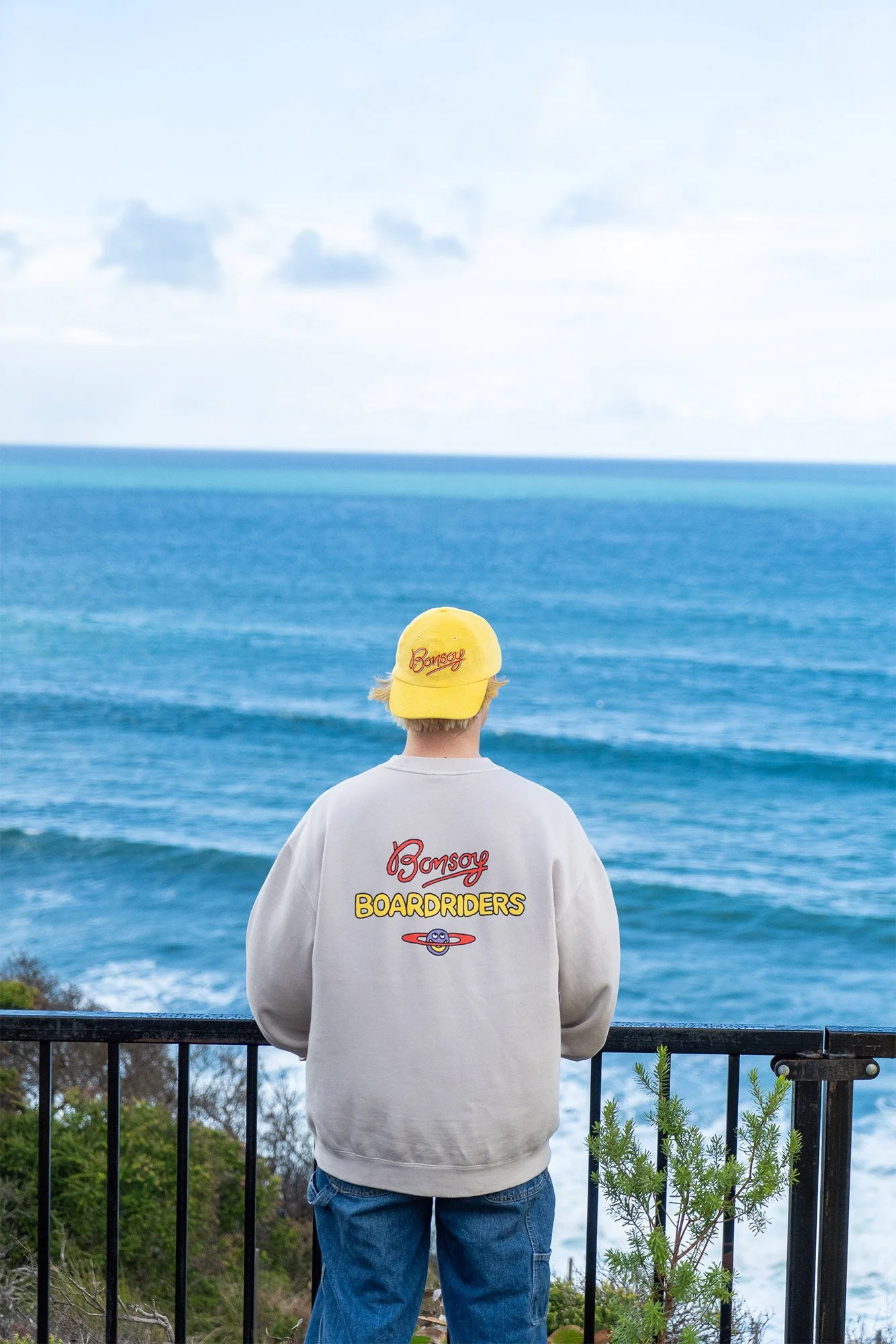 Man standing looking at surf