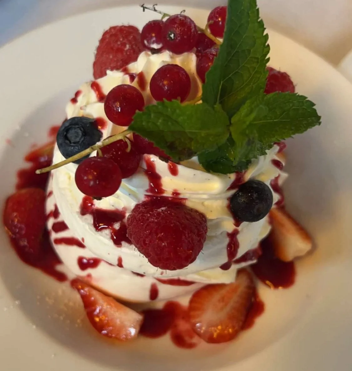 Dessert avec des fruits rouges, crème et menthe