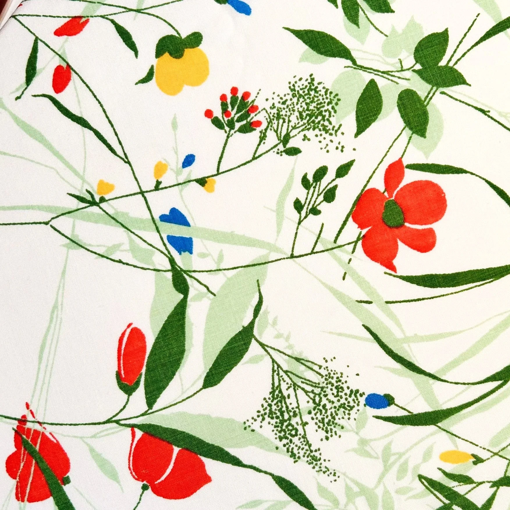 Upcycled vintage floral fabric with red, yellow, and blue flowers used for ushki pet bandanas