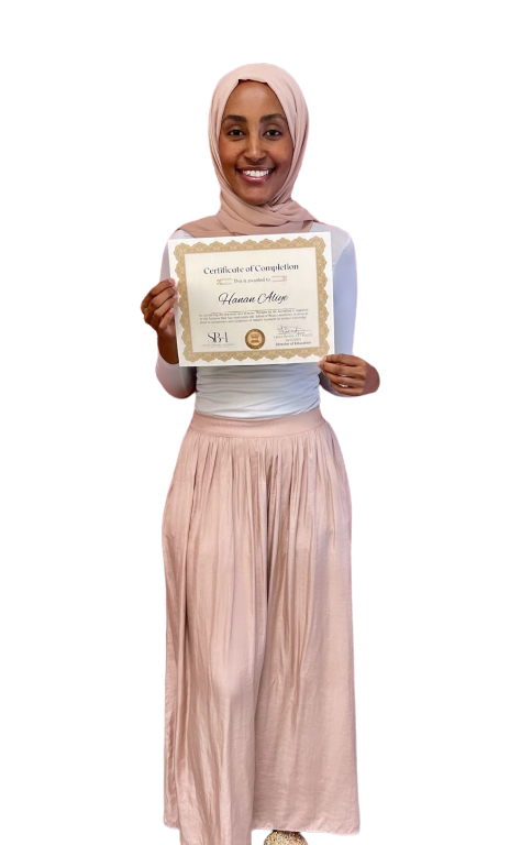 Woman wearing a hijab holding a certificate of completion, smiling.