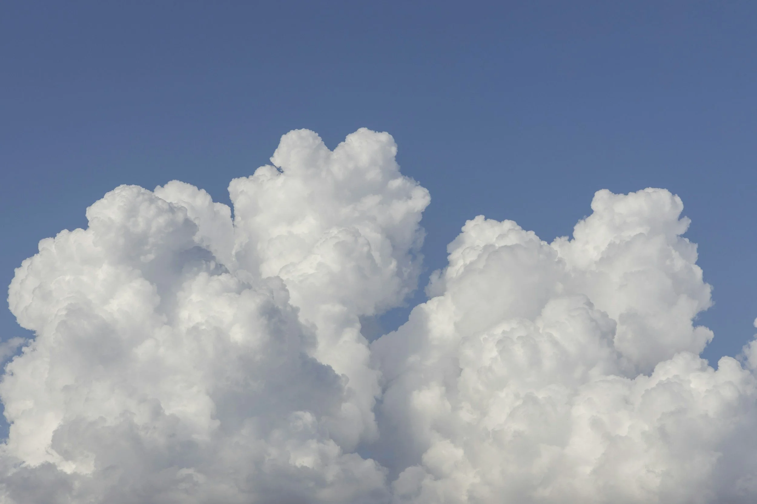 White fluffy clouds in a blue sky.
