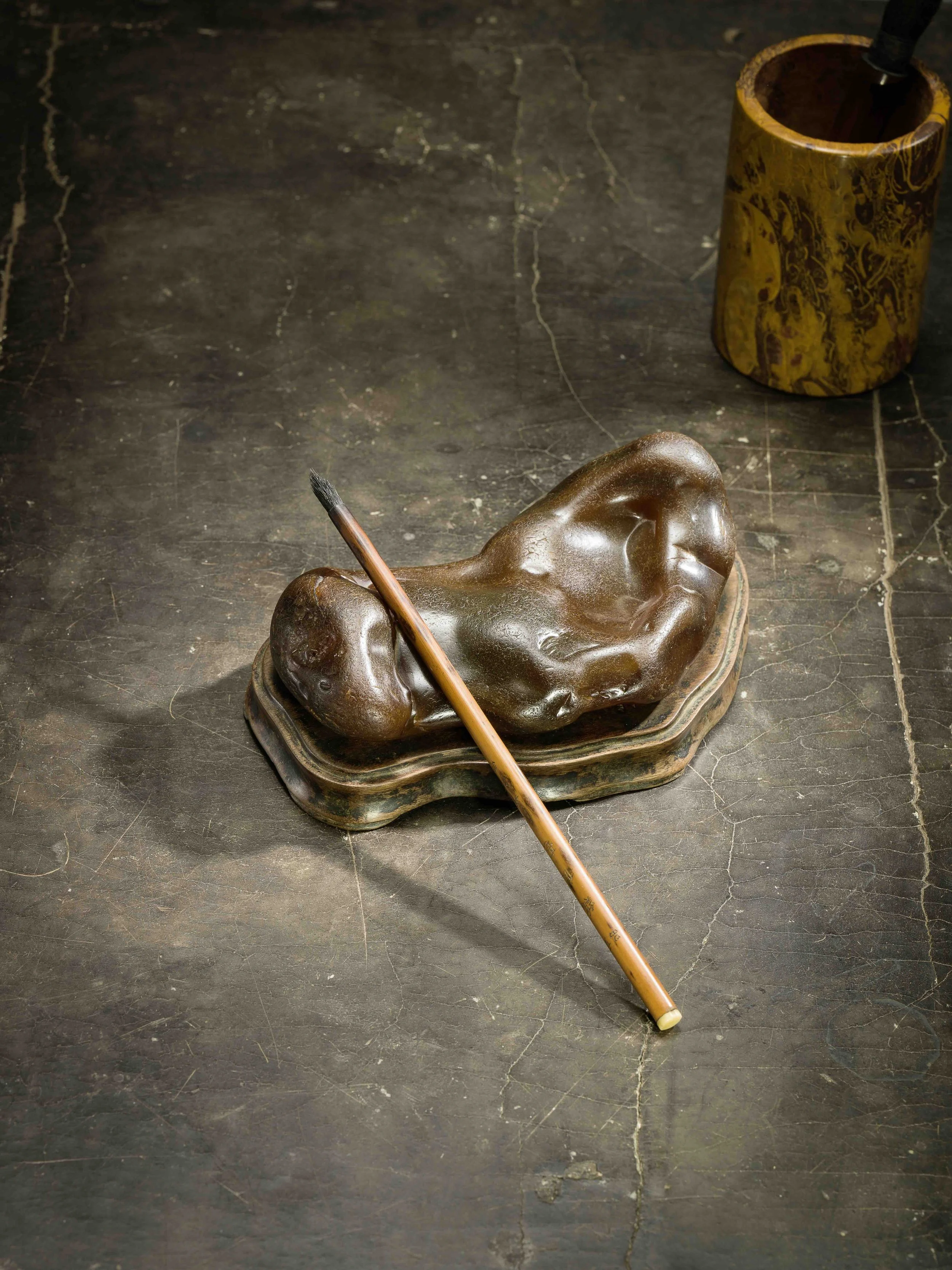 A large translucent deep russet agate pebble naturally forming a wrist rest