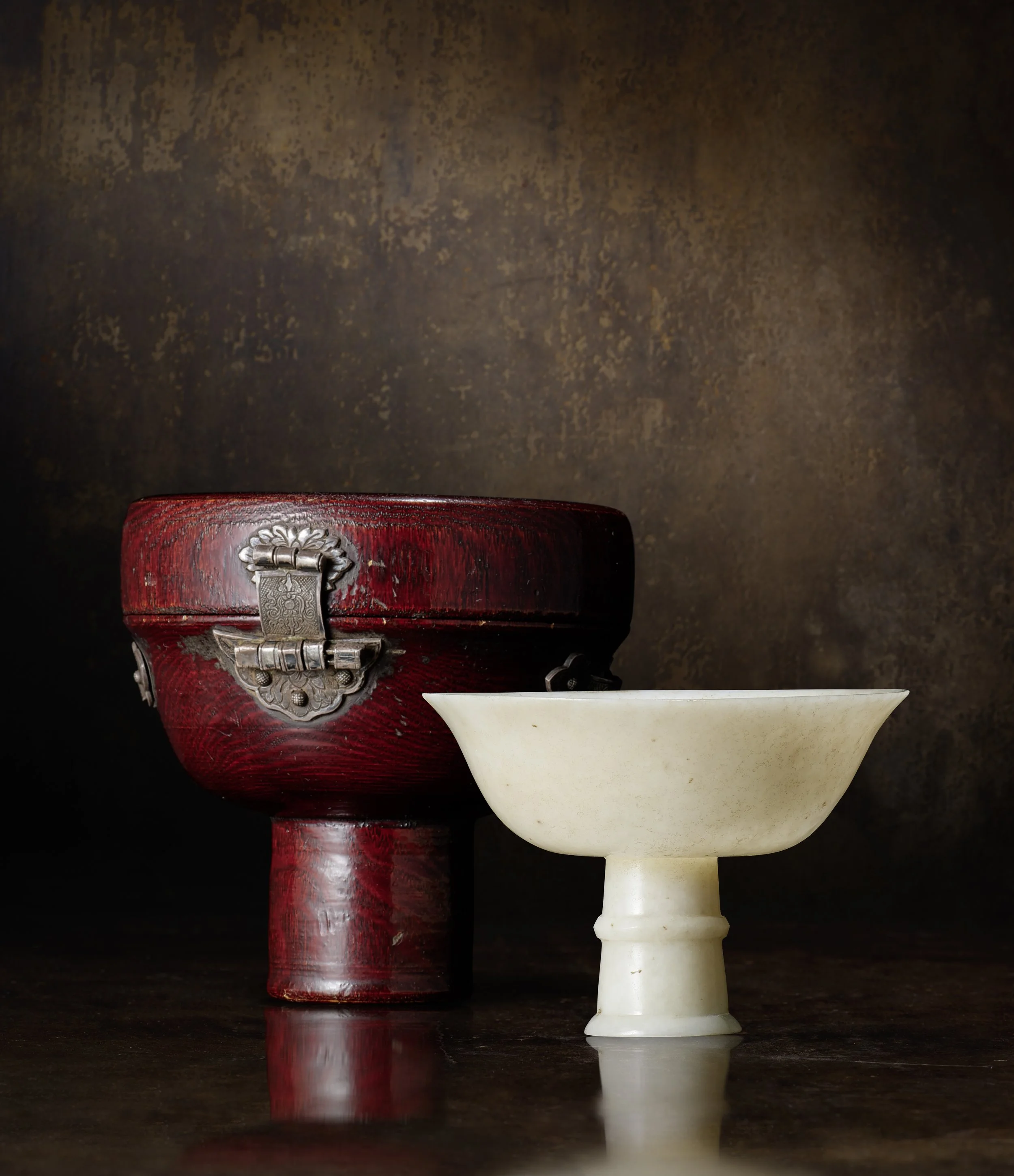 A small creamy jade stemcup, 
China: Yuan dynasty (1279-1368), with original fitted lacquered wood box mounted with foliate silver handles and lock, the interior lined in silk