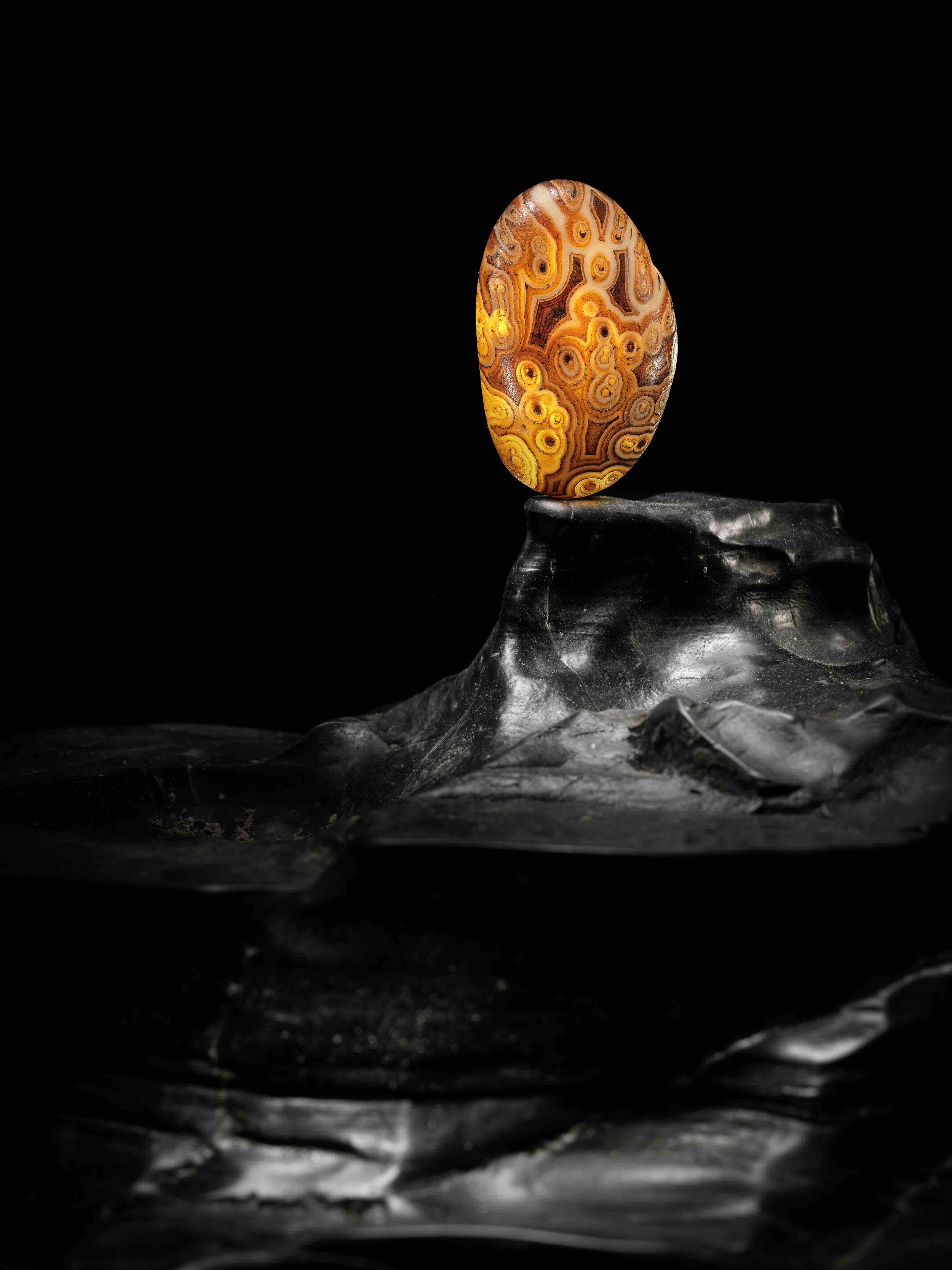 A dark-brown and caramel agate boulder