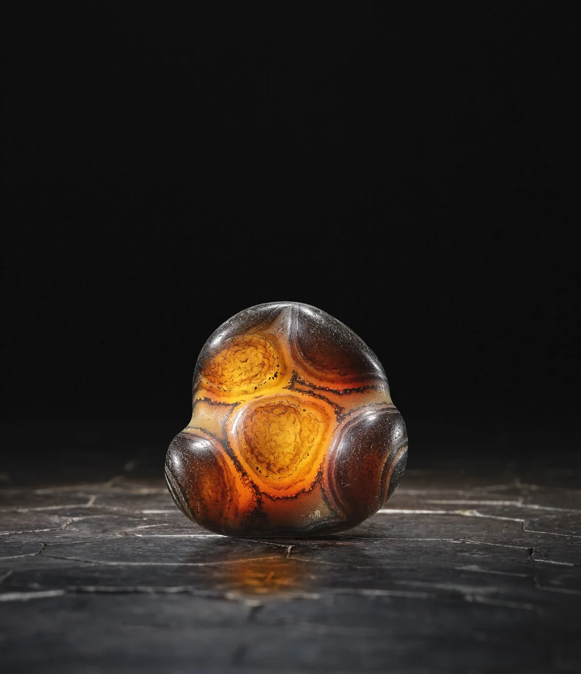 A deep-black and grey agate pebble