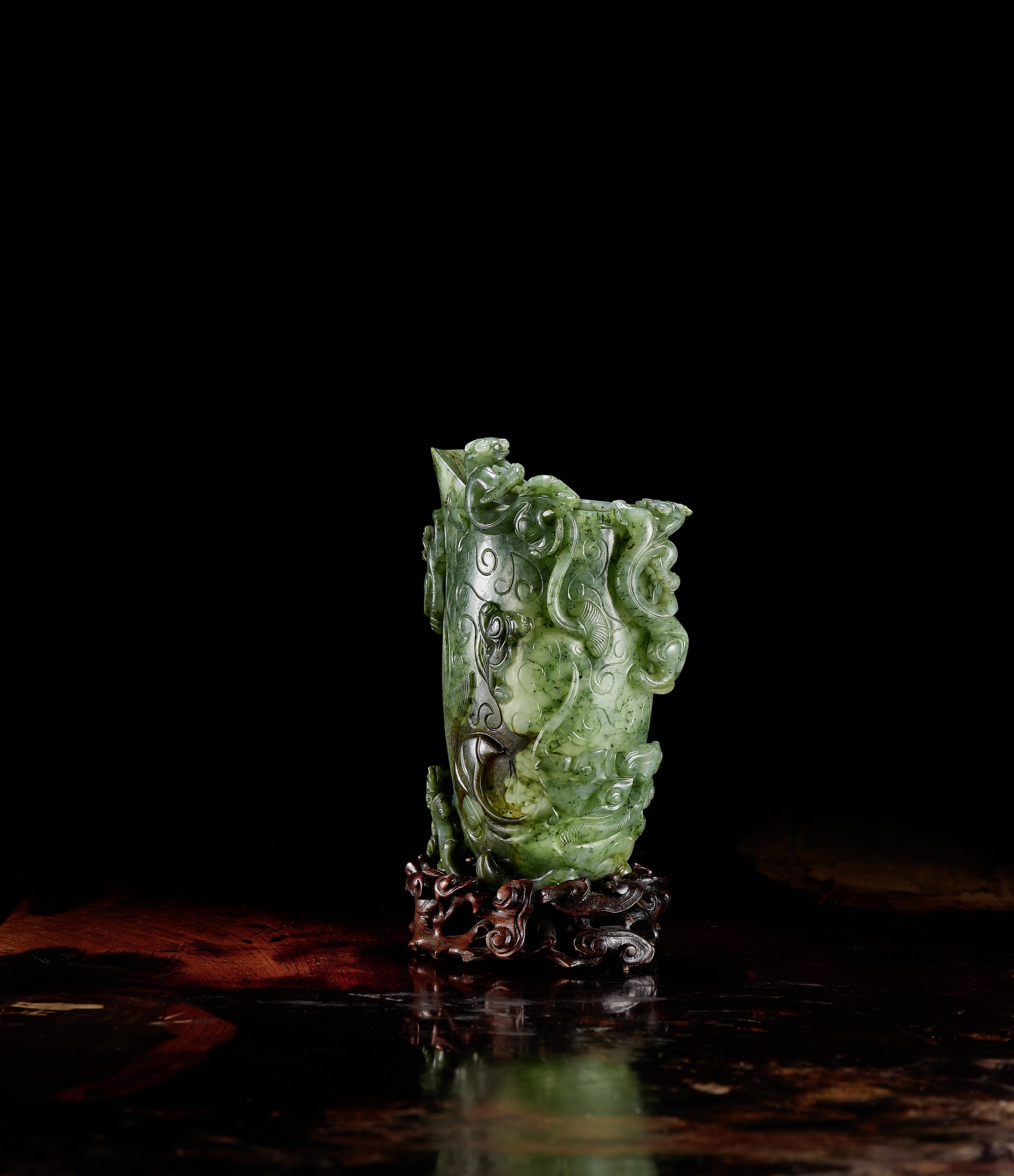 A spinach-green jade rhyton, 
China: Qianlong period (1736–95)