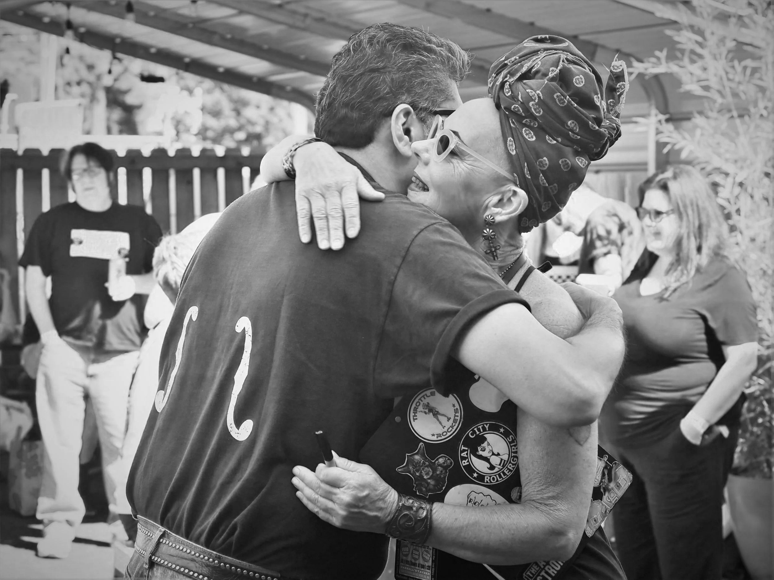 Photo of a man and woman hugging in black and white.