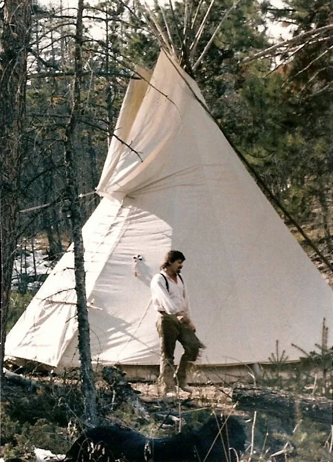 Mike Guli in front of his teepee, tipi, in a wooded area at a rendezvous in Colorado.