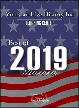 Cover of a 2019 Aurora Best of Learning Center award program with a blue background, white stars, and red and white stripes.