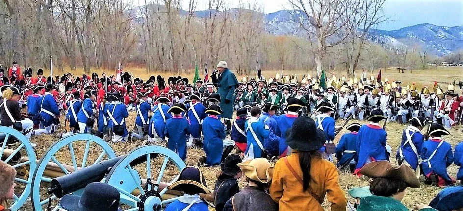 Darrell Osburn, giving directions to students in a field, for a You Can Live History Revolutionary War Battle Reenactment.