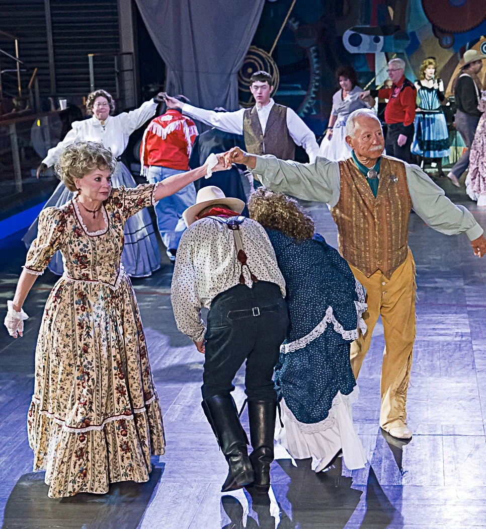 Dancers in Pioneer costumes dancing at an an Old-Time dance.