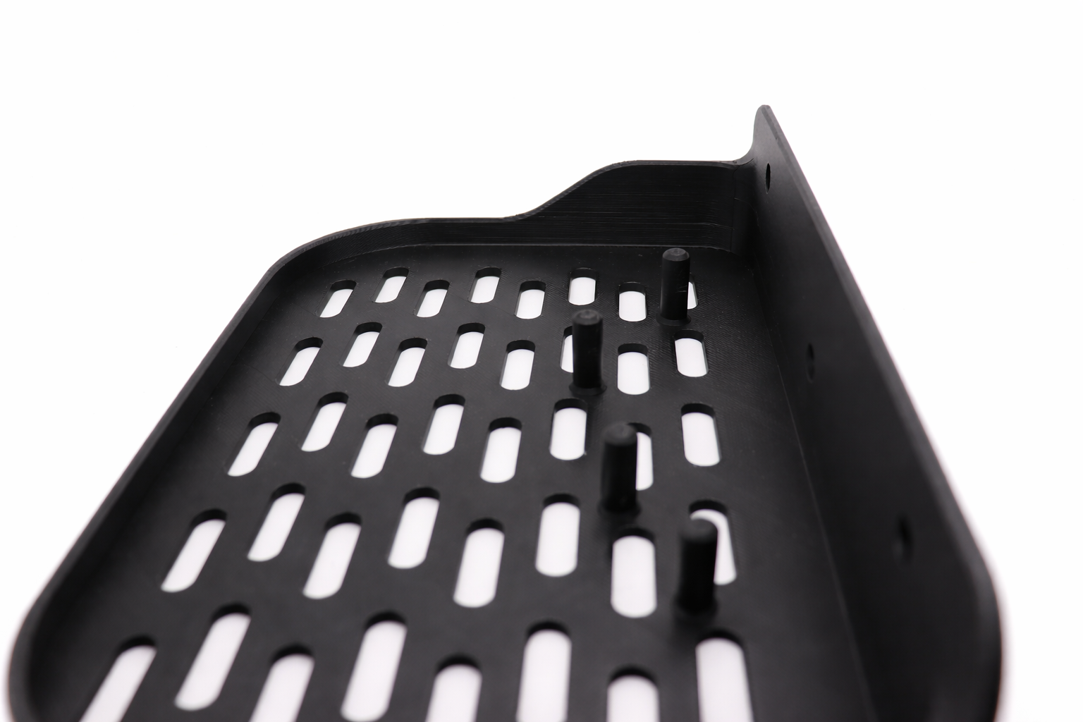Close-up of perforated black shelf.png