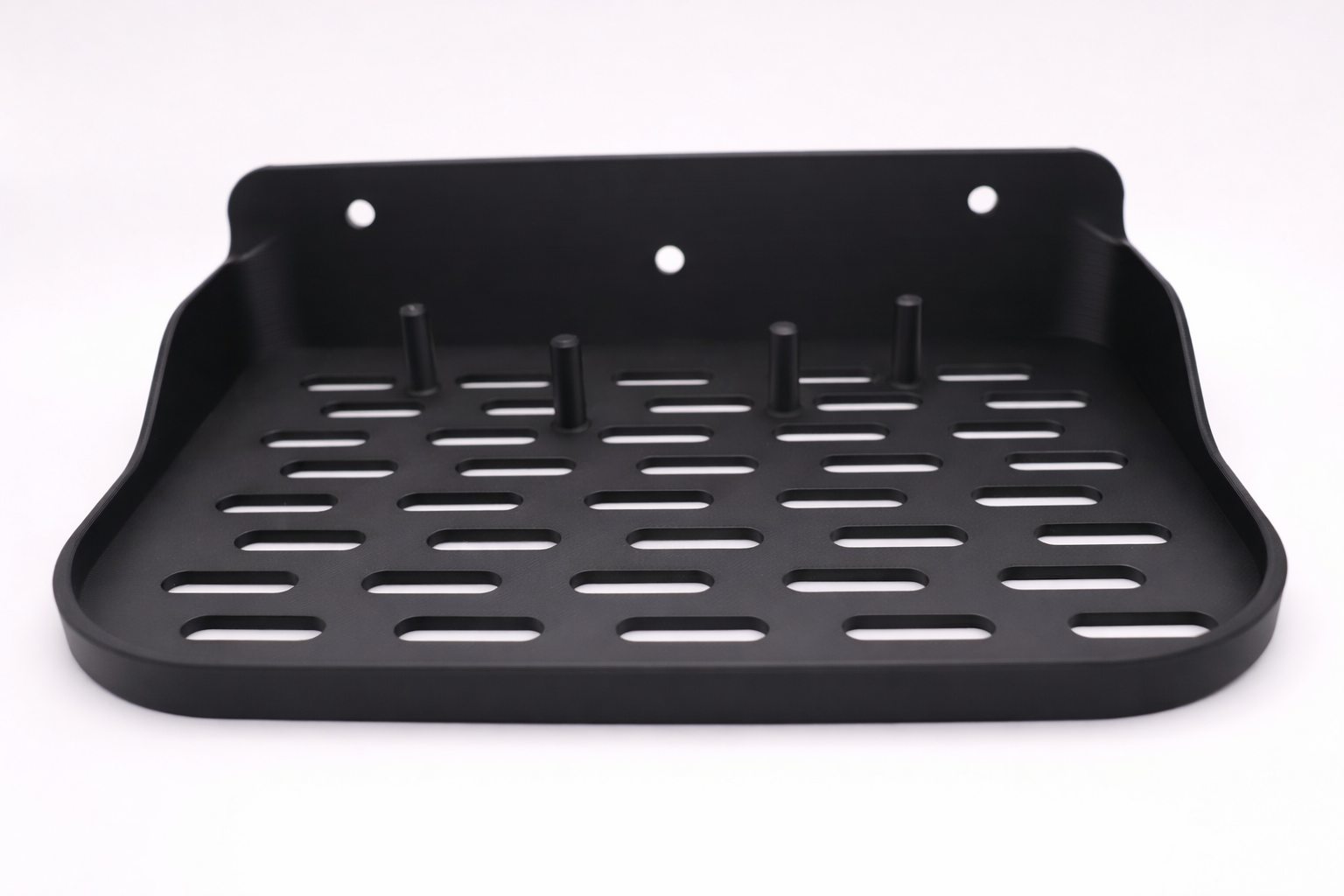 Black wall-mounted shelf basket close-up.png