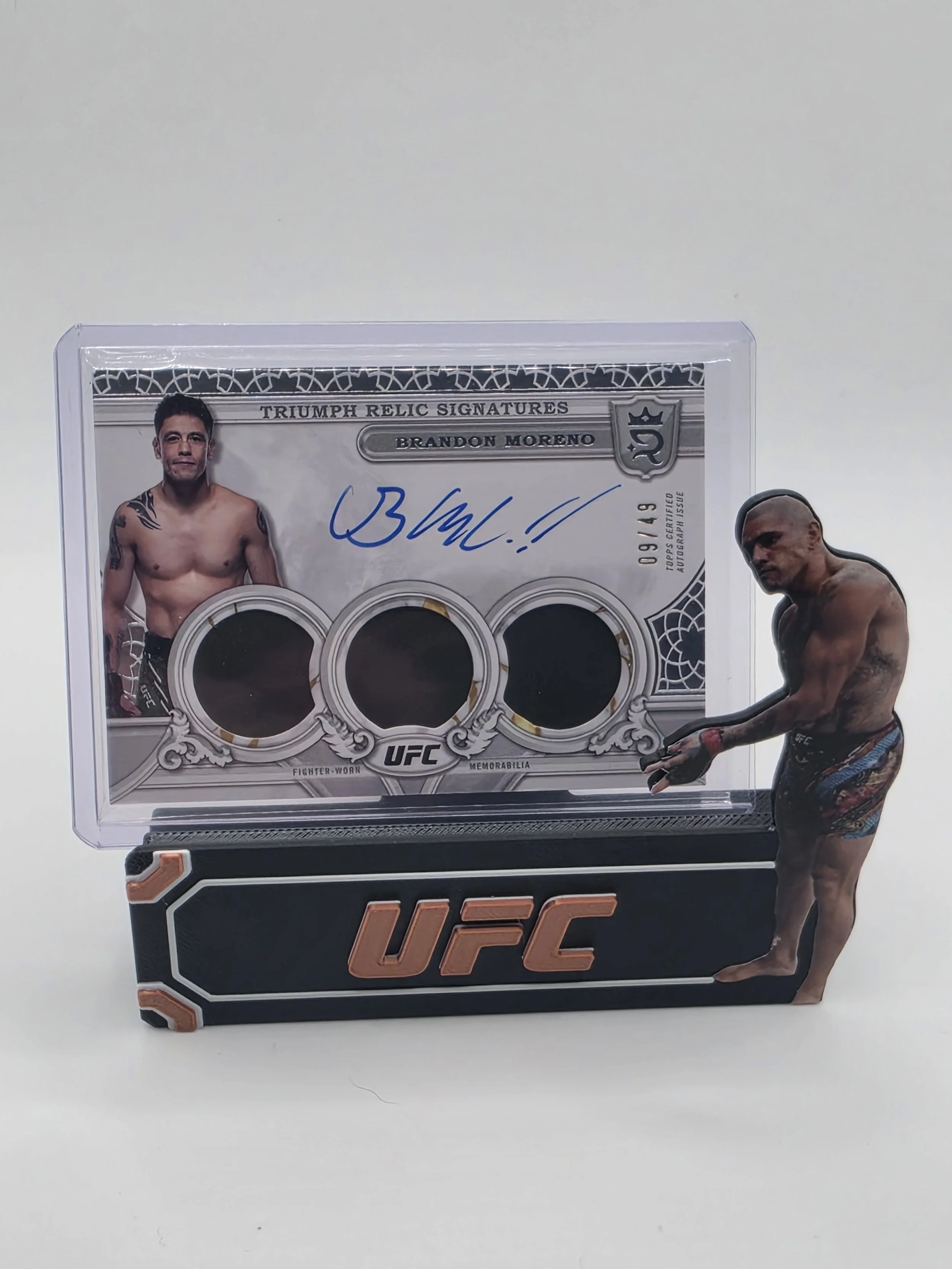 Brandon Moreno 2024 UFC Topps Royalty Triumph Relic Triple Patch Auto 09/49