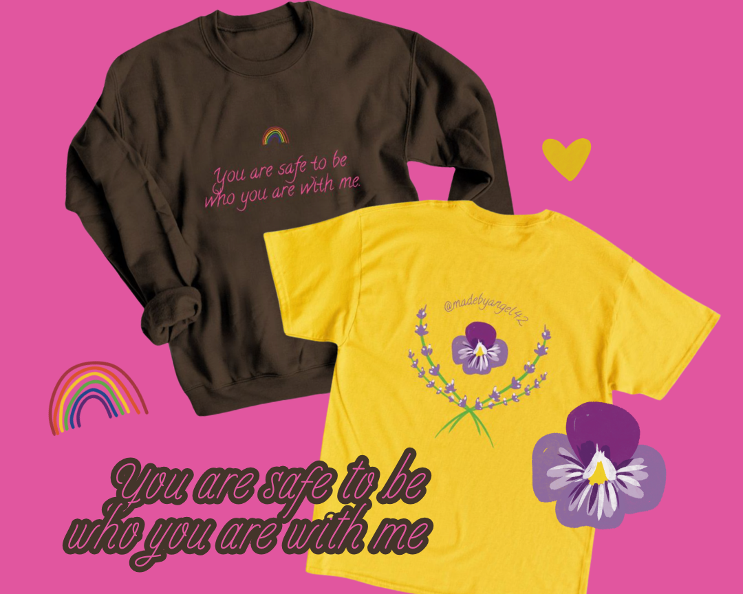 Image of two sweatshirts, one black with pink text and a rainbow, the other yellow with purple floral design and text. The background is pink with rainbow and heart illustrations. The black sweatshirt has the text "You are safe to be who you are with me." The yellow sweatshirt has the Instagram handle @madebyangel72 and a purple flower design.
