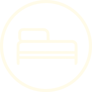 Icon of a bed within a circular border.