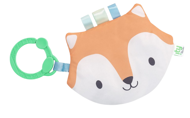 A baby teething toy shaped like a fox's face with colorful tapes on top and a green ring attached.