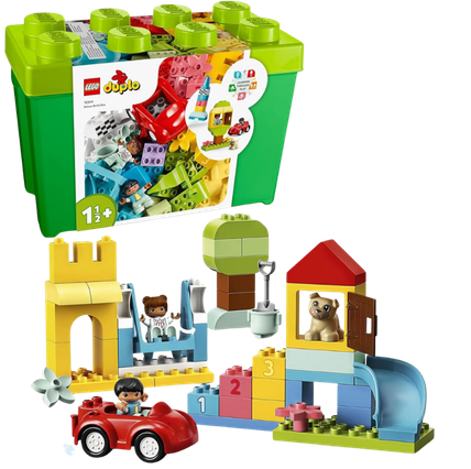 A LEGO Duplo building set with various pieces, including a yellow house, blue and red cars, a bear figure, a mouse, and a boy figure, all arranged in front of the large box packaging.