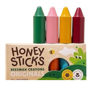Pack of four honey sticks shaped as crayons in green, pink, yellow, and red with bee and honeycomb illustrations.